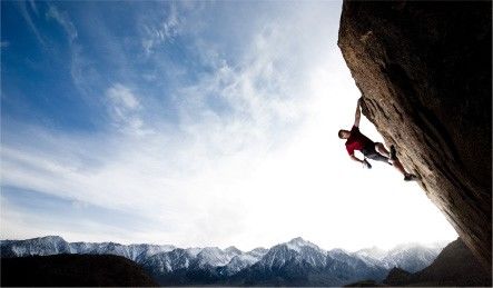 A brave climber is climbing a cliff